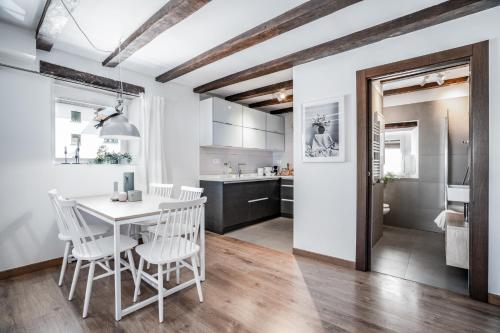 a kitchen and dining room with a table and chairs at AT rural Erro Center in Erro