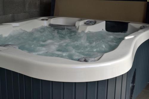 a bath tub filled with green water in a bathroom at Penzión Terra Banensium in Banská Štiavnica