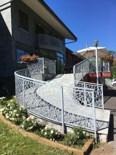 a white metal railing in front of a building at Hotel Langhe & Monferrato in Costigliole dʼAsti