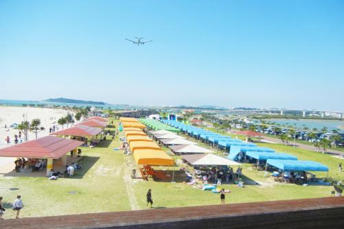 an aerial view of a beach with a group of tents at TerraceRin YN14 in Tomigusuku