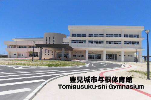 a large white building with a road in front of it at TerraceRin YN14 in Tomigusuku
