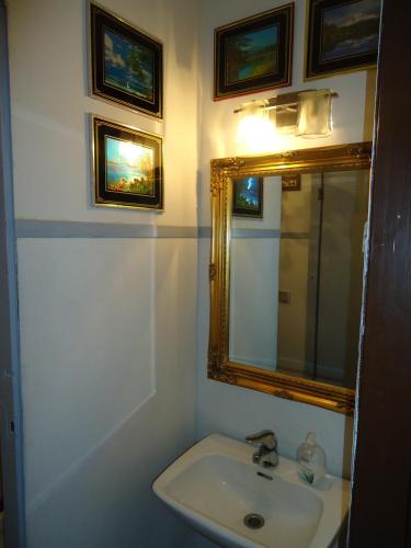 a bathroom with a sink and a mirror at Hotel Lamminpää in Tampere