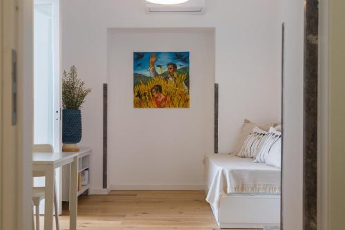 a bedroom with a bed and a painting on the wall at Villa Mallandrino in Mondello
