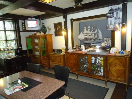 a kitchen with a table and a boat on the wall at Hotel Lamminpää in Tampere