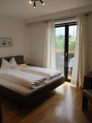 a bedroom with a bed and a large window at Garni Weghueb in Rablà