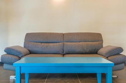 a couch with a blue table in a room at VILLA CASTELLo PORTOVENERE in Portovenere