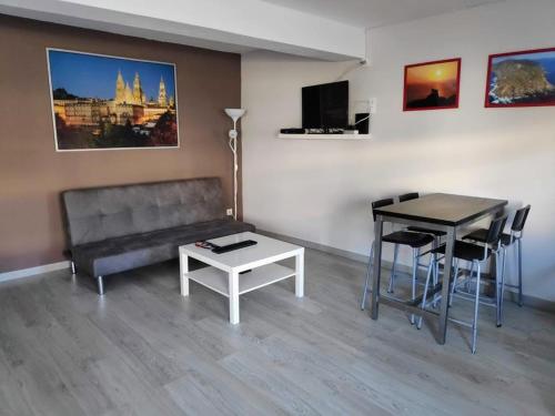 a living room with a couch and a table at Albergue Mar de Rostro in Finisterre