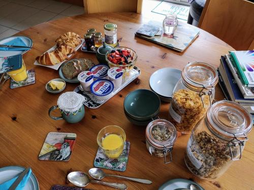 a wooden table with food and jars of breakfast foods at Room With A View in Mullinavat