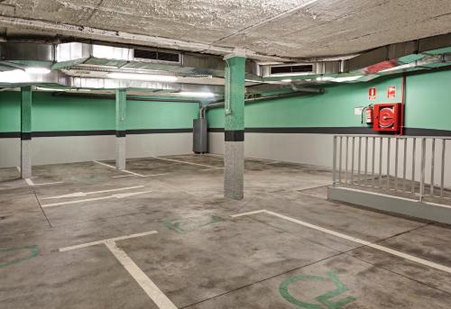 an empty parking lot in an empty parking garage at One Shot Prado in Madrid