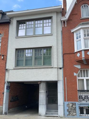 a large brick house with a garage at Hollandia City House in Hasselt