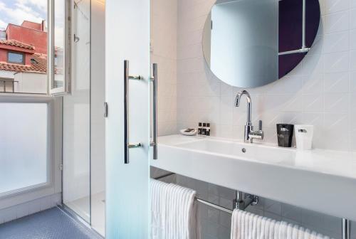 a bathroom with a sink and a mirror at One Shot Prado in Madrid