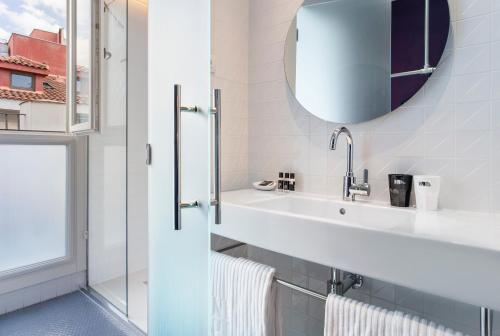 a bathroom with a sink and a mirror at One Shot Prado 23 in Madrid