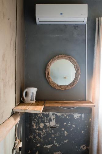 a bathroom with a mirror and a sink and a fan at The Prawn Hatchery Pty Ltd on Amatikulu in Dokodweni