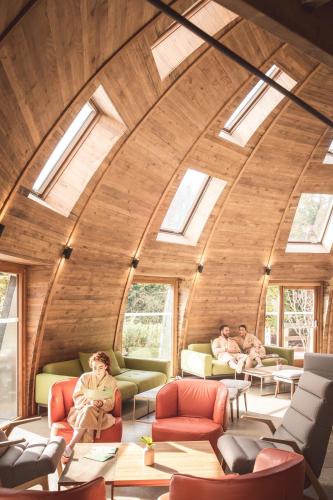 a circular room with skylights in a house with people sitting on couches at Galgorm in Ballymena