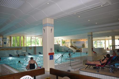 a large swimming pool with people in the water at Ferienwohnung Marion 2 in Sankt Englmar