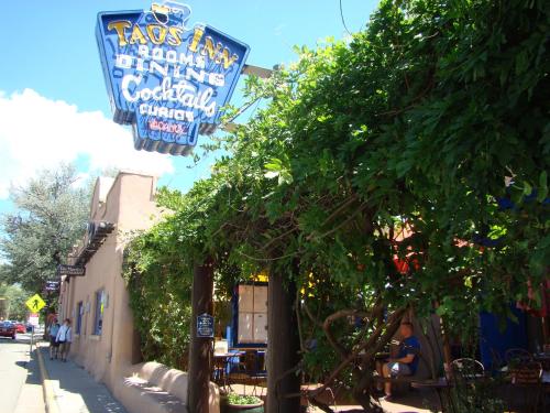 a restaurant with signs on the side of a street at The Historic Taos Inn in Taos