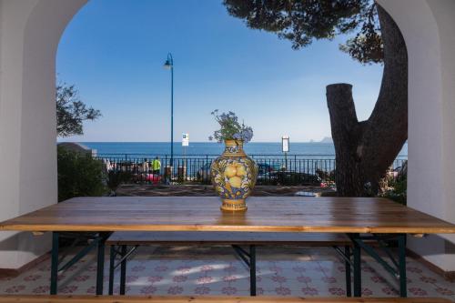 a vase sitting on top of a wooden table at Villa Mallandrino in Mondello
