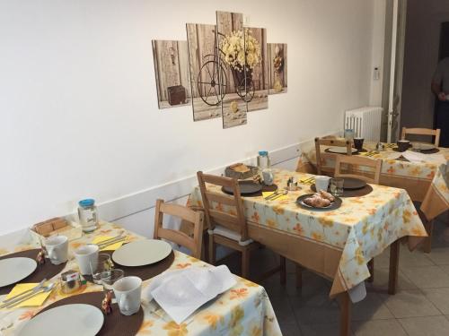 a dining room with tables and chairs with food on them at Golden Rooms Bed & Breakfast in Trieste