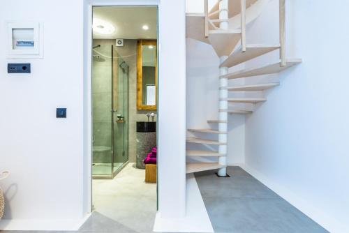 a staircase in a house with white walls at Portes Suites & Villas Mykonos in Mýkonos City