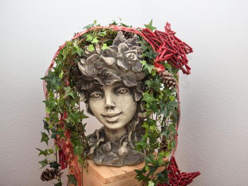 a statue of a woman with areath of ivy at Landhaus Gastein in Dorfgastein