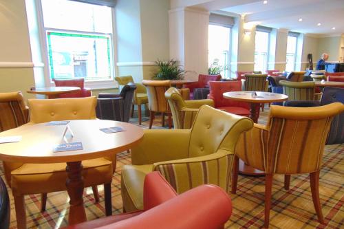 a restaurant with tables and chairs in a room at The Lakeland Kendal Hotel, Sure Hotel Collection by Best Western in Kendal