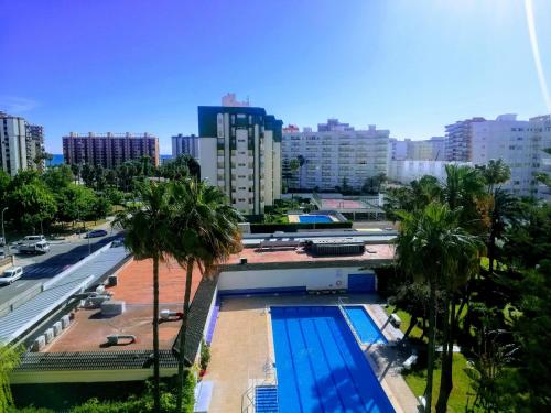 a view of a swimming pool in a city at Parque IV Solo Familias Serviplaya in Gandía