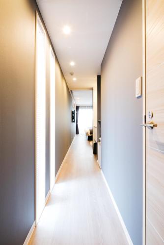 a corridor of an office building with a long hallway at FUKUOKA MOJIKO STAY in Kitakyushu