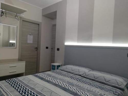 a bedroom with a bed and a dresser and a mirror at Lagrange 23 in Cambiano