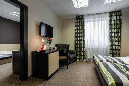 a hotel room with a bed and a television at BNC Hotel - Restaurant - Bowling in Bratislava