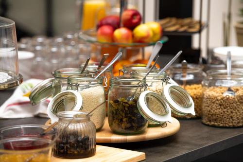 a table topped with jars of food and nuts at Hotell Kvarntorget in Uppsala
