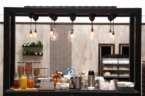 a kitchen with a counter with lights on it at Hotell Kvarntorget in Uppsala
