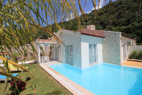 a villa with a swimming pool and a house at Z Exclusive Hotel and Villas in Oludeniz