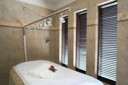 a bathroom with a bed with flowers on it at Lagoon Attitude (Adults Only) in Cap Malheureux