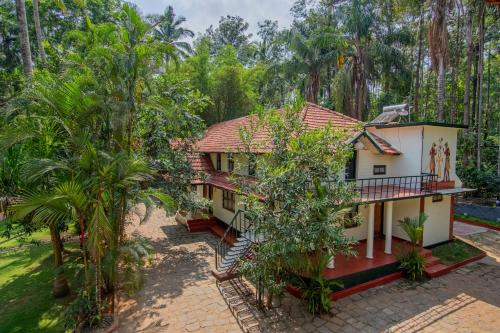 an aerial view of a house with trees at Orchid Trails Resort in Sultan Bathery