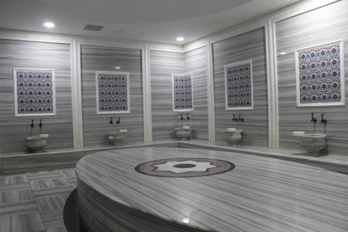 a room with a table and four toilets in it at Asrin Park Hotel & Spa Convention Center in Ankara