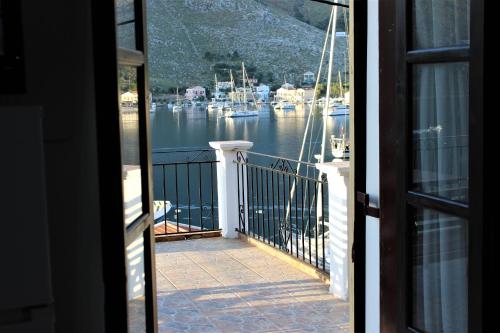 a view of a marina from a house balcony at Gompos Apartment - Cozy Apartment next to the sea - Amazing Sea View in Symi