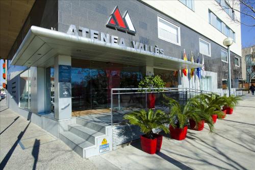 a store with plants in front of a building at Aparthotel Atenea Valles in Granollers