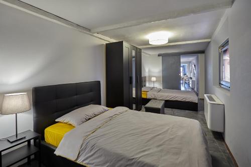 a bedroom with a bed and a room with two beds at San Giorgio 2 in Bologna