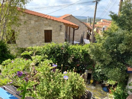 a garden in front of a stone house at Ble Mavi - Studio for 2 in Vouni