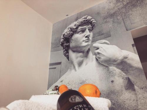 a painting of a statue of a man in a bath tub at Amantea Monument in Terrasini