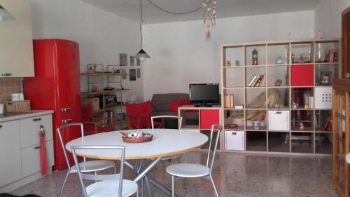 a kitchen with a table and chairs in a room at Happy House Corricella in Procida