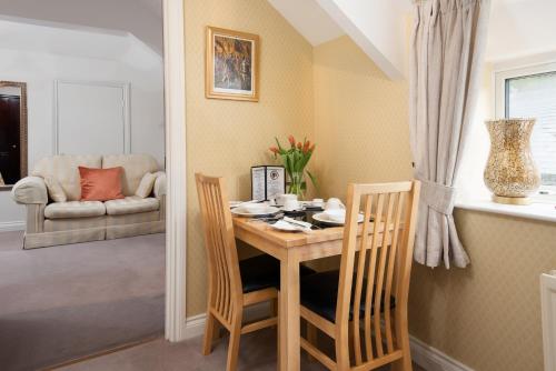 a dining room table with two chairs and a table and chairsktop at Coach House B & B in Alnwick