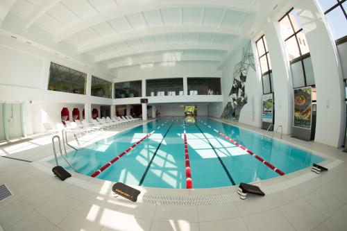 an indoor swimming pool with a large pool at WISH Aqua&SPA Resort in Vishenki