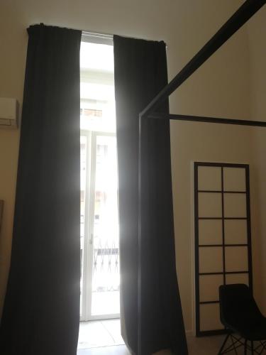 a window with black curtains in a room at Gatto Bianco Duchessa in Bari