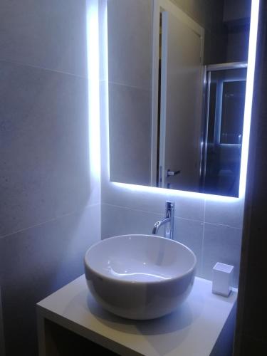 a bathroom with a white sink and a mirror at Gatto Bianco Duchessa in Bari