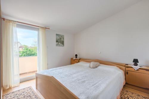 a bedroom with a bed and a large window at Haus Glavani in Barban