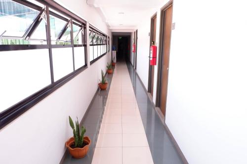an empty corridor in an office building with potted plants at My North Star Hotel in Tarlac