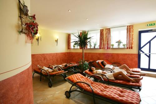 a group of people laying on couches in a waiting room at Hotel Garni Thermenoase in Bad Blumau