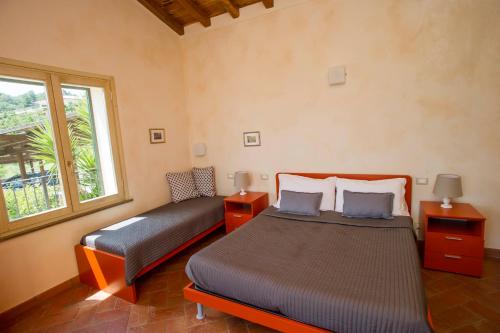 a bedroom with two beds and a window at Il Casale in Capoliveri