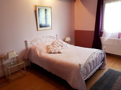 a bedroom with a bed and a window at Chambres d'Hôtes La Noyeraie in Izeron